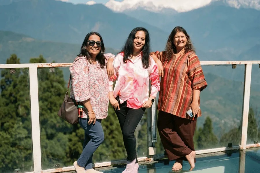 Three travelers taking in the Himalayan scenery