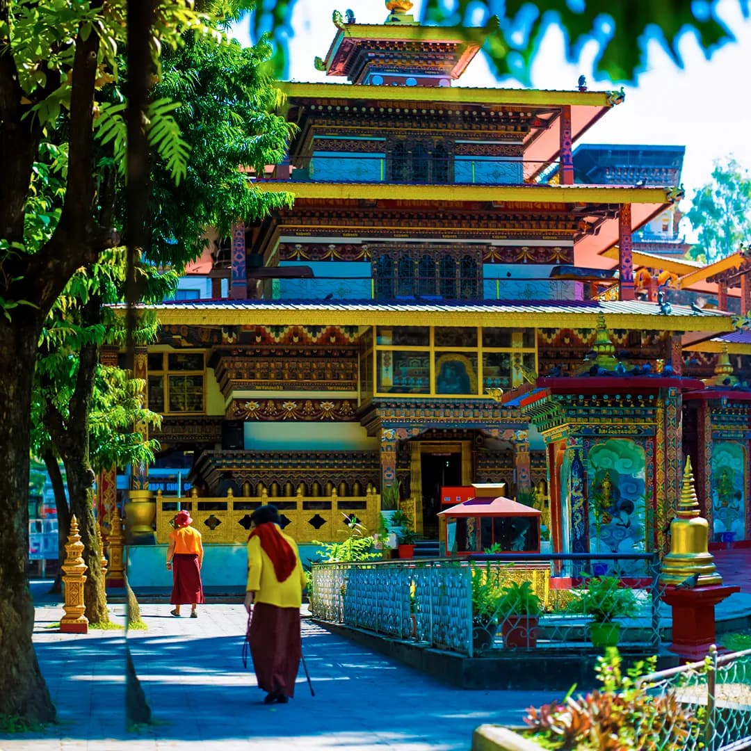 Colourful Himalayan monastery surrounded by lush greenery