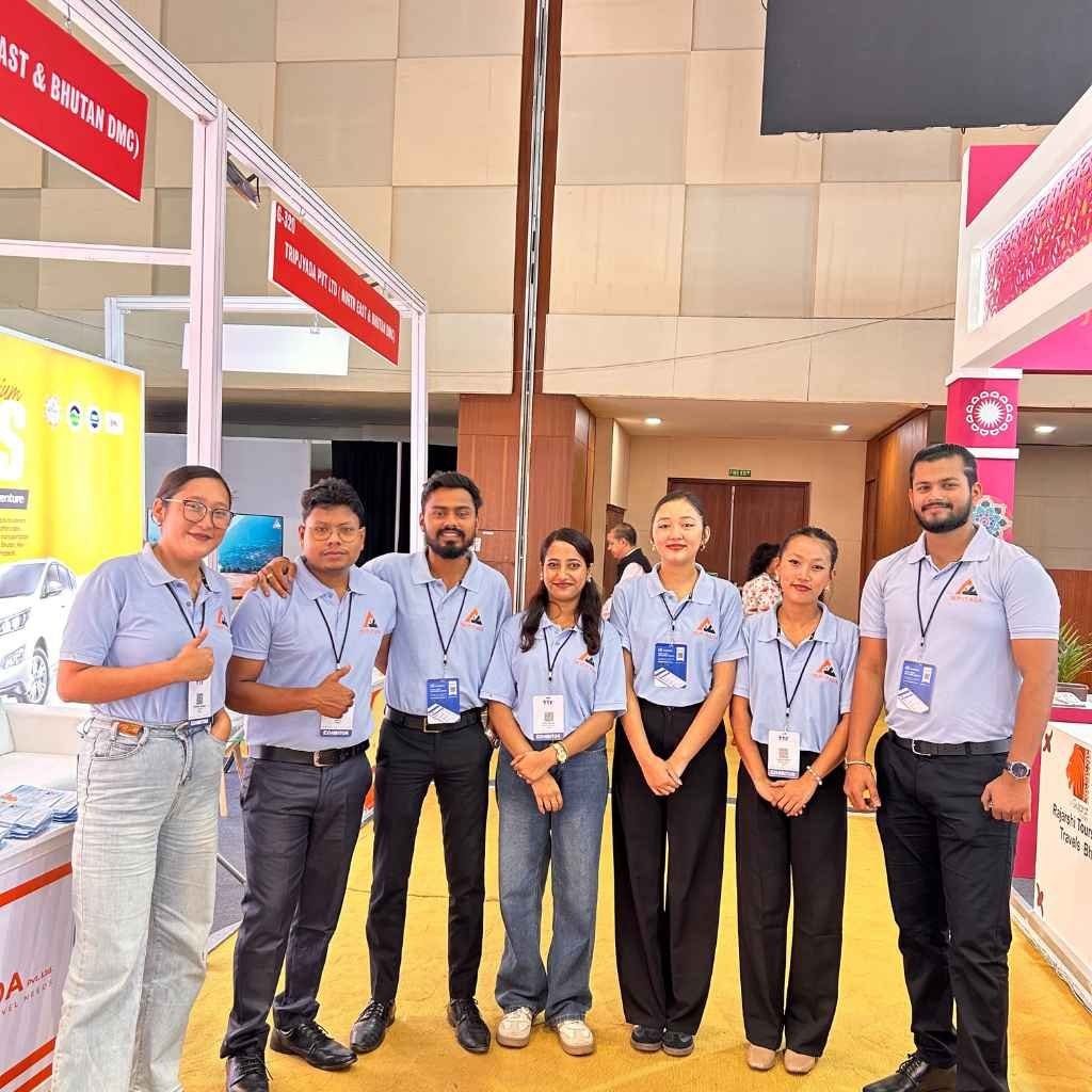 The Tripjyada team in matching shirts at a travel industry event